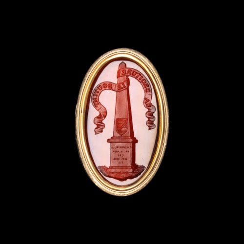 A gold ring set with a Grand Tour carnelian intaglio. Obelisk with coat arms.